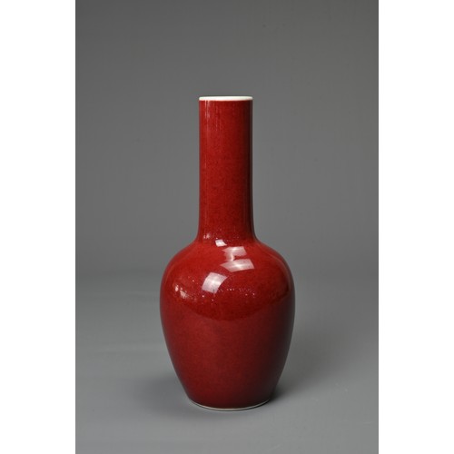 40 - A CHINESE RED GLAZED PORCELAIN BOTTLE VASE, KANGXI MARK. Ovoid body leading into to a tall cylindric... 