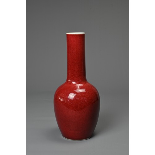 40 - A CHINESE RED GLAZED PORCELAIN BOTTLE VASE, KANGXI MARK. Ovoid body leading into to a tall cylindric... 