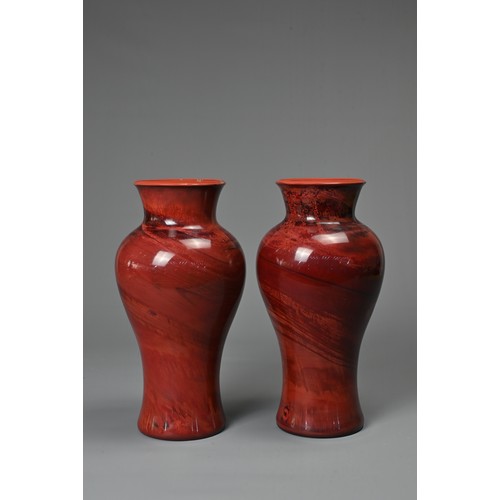 44 - A PAIR OF CHINESE REALGAR GLASS VASES, 19/20TH CENTURY. Each of baluster form carved from red glass ... 