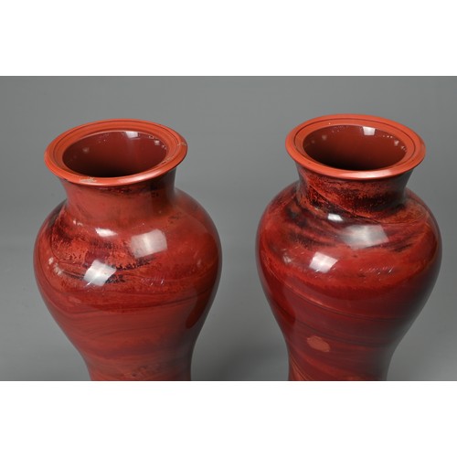 44 - A PAIR OF CHINESE REALGAR GLASS VASES, 19/20TH CENTURY. Each of baluster form carved from red glass ... 