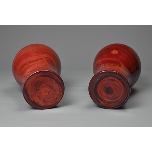 44 - A PAIR OF CHINESE REALGAR GLASS VASES, 19/20TH CENTURY. Each of baluster form carved from red glass ... 