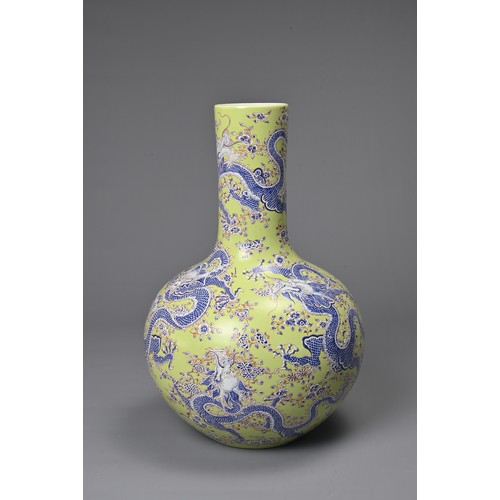 47 - A CHINESE LIME GREEN GROUND TIANQIUPING, KANGXI MARK, 20TH CENTURY. Globular body leading into a tal... 