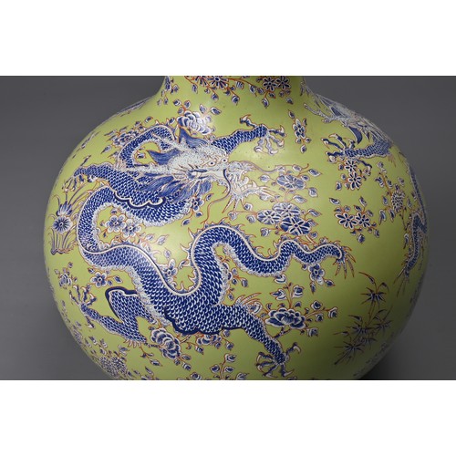 47 - A CHINESE LIME GREEN GROUND TIANQIUPING, KANGXI MARK, 20TH CENTURY. Globular body leading into a tal... 