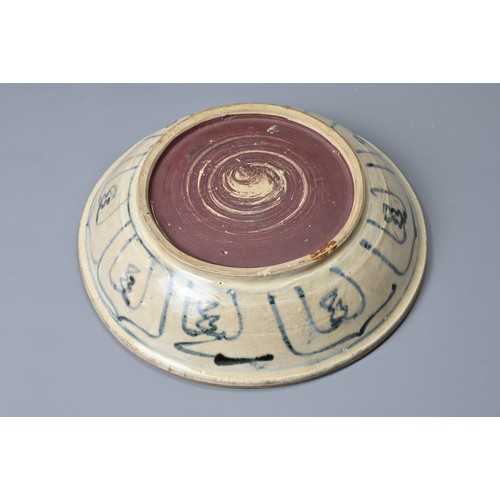 72 - A VIETNAMESE BLUE AND WHITE PORCELAIN DISH, 15TH/16TH CENTURY. Heavily potted and decorated in under... 