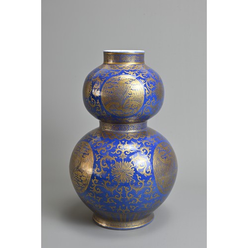 42 - A CHINESE BLUE GROUND AND GILT DECORATED DOUBLE GOURD PORCELAIN VASE, 19/20TH CENTURY. Well decorate... 