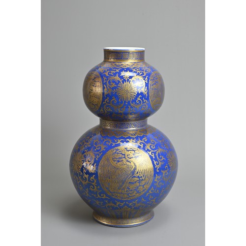 42 - A CHINESE BLUE GROUND AND GILT DECORATED DOUBLE GOURD PORCELAIN VASE, 19/20TH CENTURY. Well decorate... 