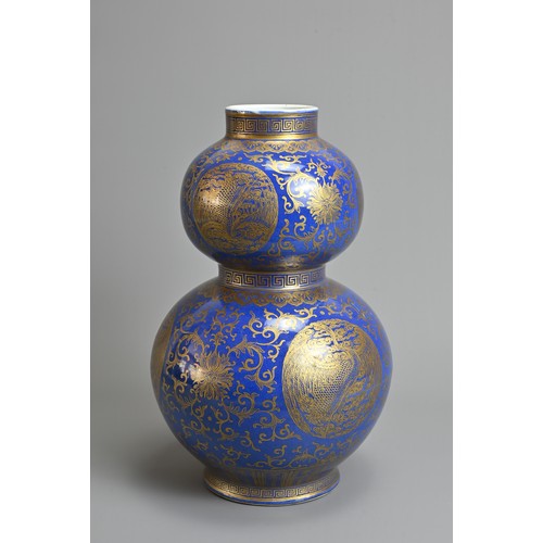 42 - A CHINESE BLUE GROUND AND GILT DECORATED DOUBLE GOURD PORCELAIN VASE, 19/20TH CENTURY. Well decorate... 