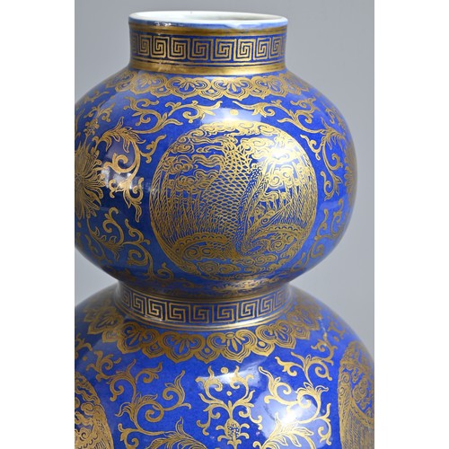 42 - A CHINESE BLUE GROUND AND GILT DECORATED DOUBLE GOURD PORCELAIN VASE, 19/20TH CENTURY. Well decorate... 