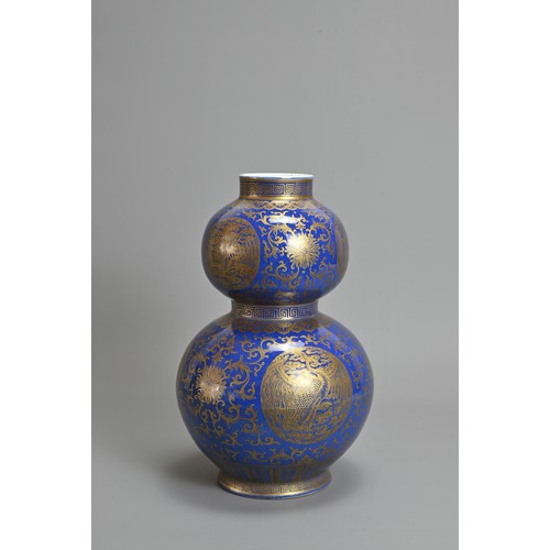 42 - A CHINESE BLUE GROUND AND GILT DECORATED DOUBLE GOURD PORCELAIN VASE, 19/20TH CENTURY. Well decorate... 