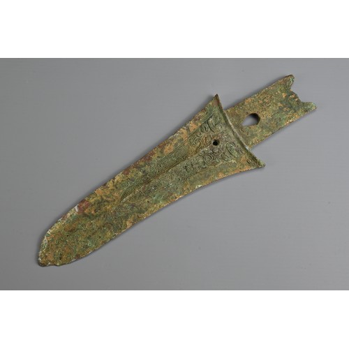 213 - A CHINESE ARCHAIC BRONZE DAGGER AXE, GE. Decorated with taotie mask to each side. Possibly Western Z... 