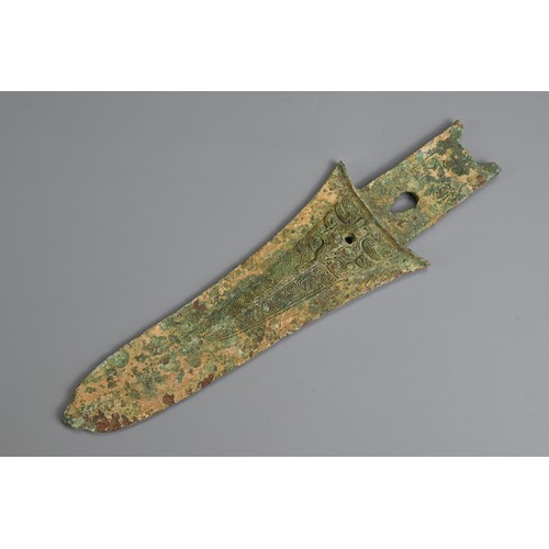 213 - A CHINESE ARCHAIC BRONZE DAGGER AXE, GE. Decorated with taotie mask to each side. Possibly Western Z... 