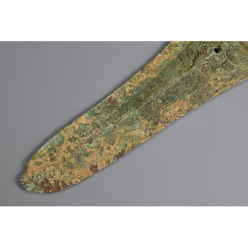 213 - A CHINESE ARCHAIC BRONZE DAGGER AXE, GE. Decorated with taotie mask to each side. Possibly Western Z... 