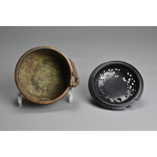 6 - A CHINESE BRONZE CENSER. Heavily cast of rounded form with figure of chilong and two character mark ... 