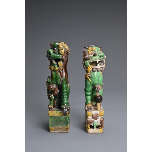 10 - TWO CHINESE SANCAI GLAZED POTTERY JOSS STICK HOLDERS, QING DYNASTY. Buddhistic lions modelled seated... 