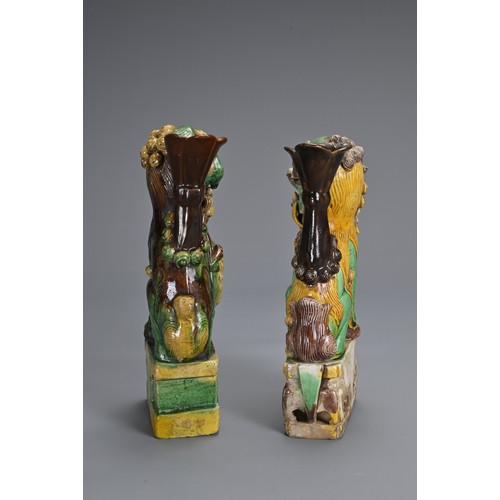 10 - TWO CHINESE SANCAI GLAZED POTTERY JOSS STICK HOLDERS, QING DYNASTY. Buddhistic lions modelled seated... 