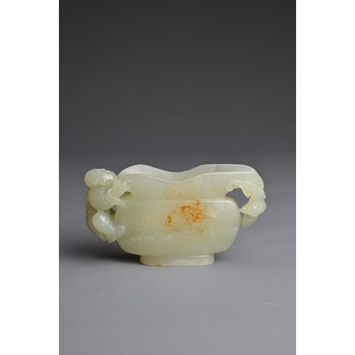 26 - A CHINESE CARVED PALE CELADON JADE CUP. Pale celadon colour with russet patches, featuring a boy han... 