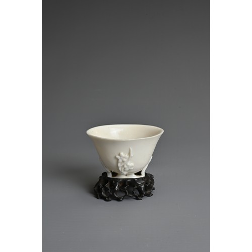 34 - A CHINESE BLANC DE CHINESE PORCELAIN LIBATION CUP, 17TH CENTURY. With applied floral sprays on an op... 