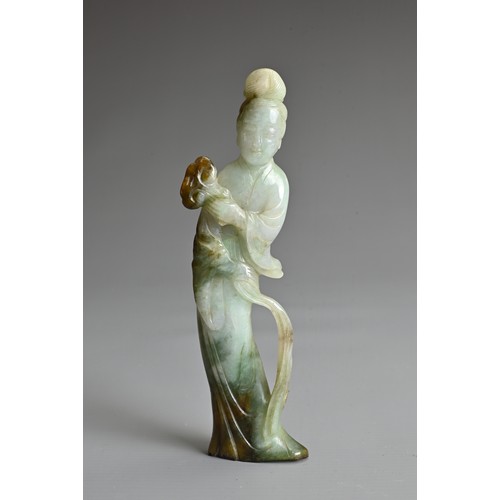 45 - A CHINESE CARVED JADE FIGURE OF GUANYIN, QING DYNASTY. The figure standing dressed in robes holding ... 