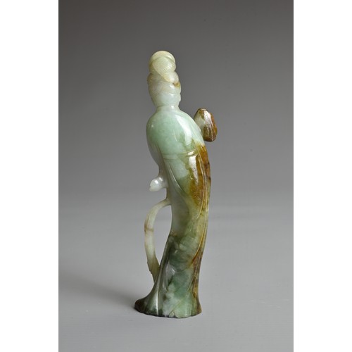 45 - A CHINESE CARVED JADE FIGURE OF GUANYIN, QING DYNASTY. The figure standing dressed in robes holding ... 