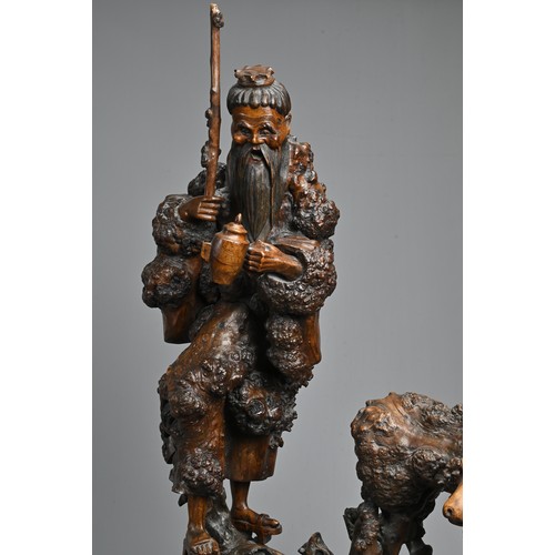 54 - TWO VERY LARGE CHINESE ROOT CARVINGS, 19TH CENTURY. Sectional figures on stands of immortals and buf... 