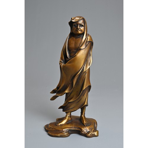 300 - A 20TH CENTURY JAPANESE GILT BRONZE FIGURE OF DARUMA AFTER KOUN TAKAMURA (1852-1934). Cast standing ... 