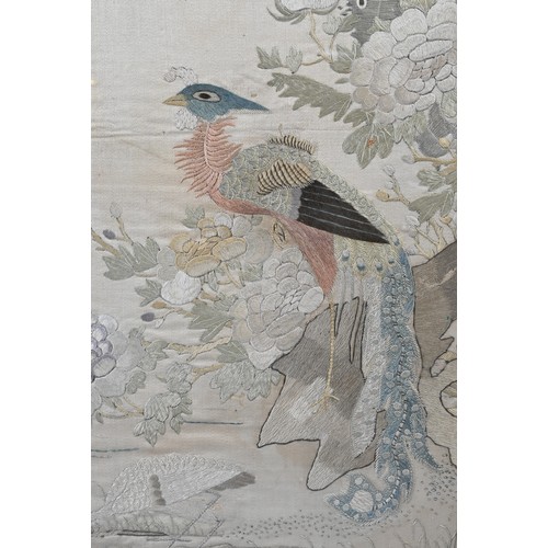 59 - A CHINESE QING DYNASTY EMBROIDERED SILK PANEL. Of rectangular form, depicting a phoenix perched on r... 