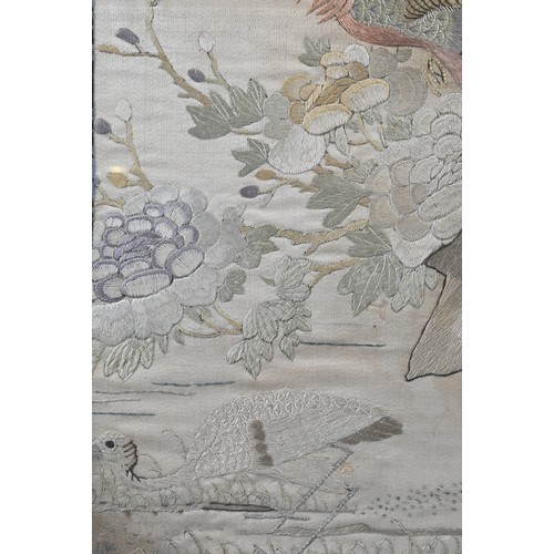 59 - A CHINESE QING DYNASTY EMBROIDERED SILK PANEL. Of rectangular form, depicting a phoenix perched on r... 