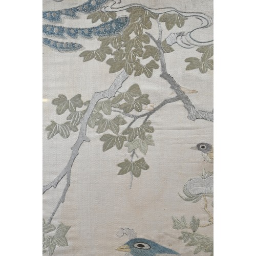 59 - A CHINESE QING DYNASTY EMBROIDERED SILK PANEL. Of rectangular form, depicting a phoenix perched on r... 