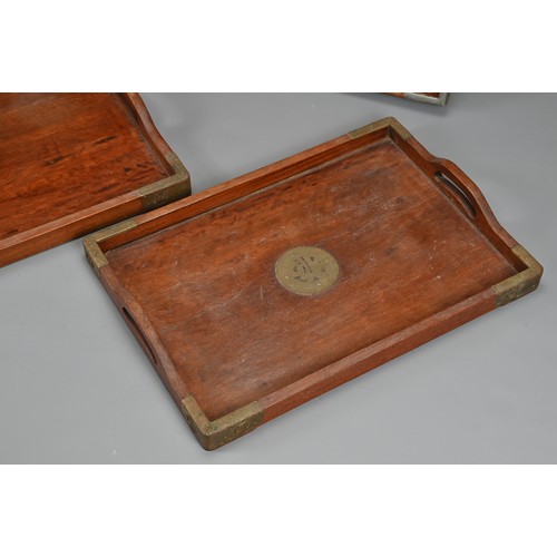 56 - THREE CHINESE WOOD TRAYS, EARLY 20TH CENTURY. To include a rectangular tray with metal dragons and x... 