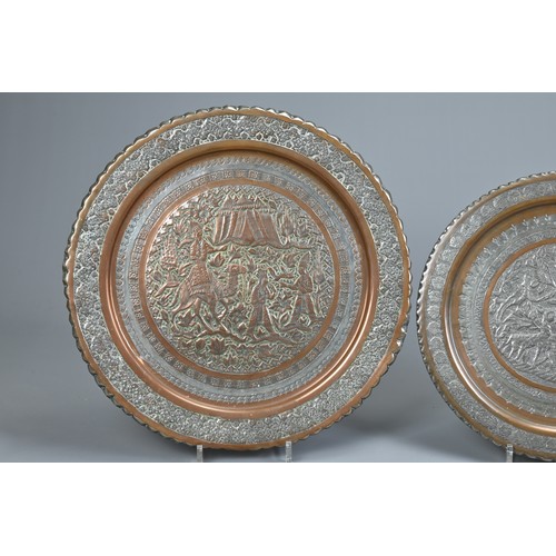 304 - TWO MIDDLE EASTERN TINNED COPPER DISHES, 20TH CENTURY. The first decorated in low relief with deer i... 