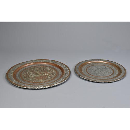 304 - TWO MIDDLE EASTERN TINNED COPPER DISHES, 20TH CENTURY. The first decorated in low relief with deer i... 