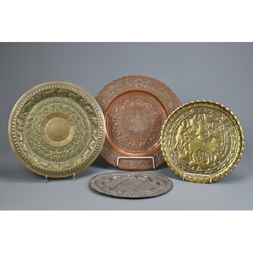 305 - FOUR INDO-PERSIAN BRASS AND COPPER DISHES, LATE 19TH/EARLY 20TH CENTURY. Comprising: a tinned copper... 