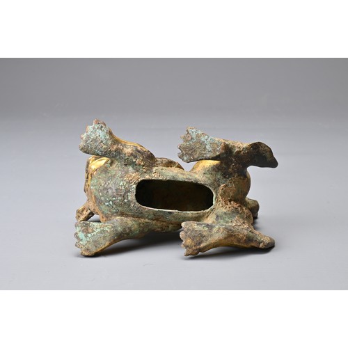 181 - A CHINESE GILT BRONZE FIGURE OF A LION, MING DYNASTY STYLE. In a playful position with its head turn... 