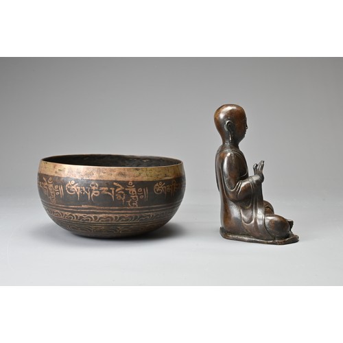 182 - TWO CHINESE TIBETAN BRONZE ITEMS. To include a singing bowl with banded decoration and Tibetan scrip... 