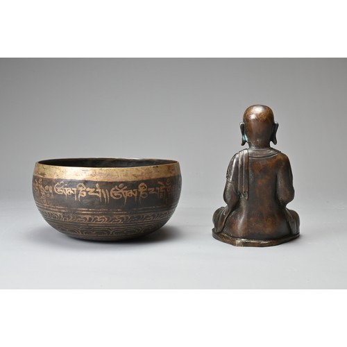 182 - TWO CHINESE TIBETAN BRONZE ITEMS. To include a singing bowl with banded decoration and Tibetan scrip... 