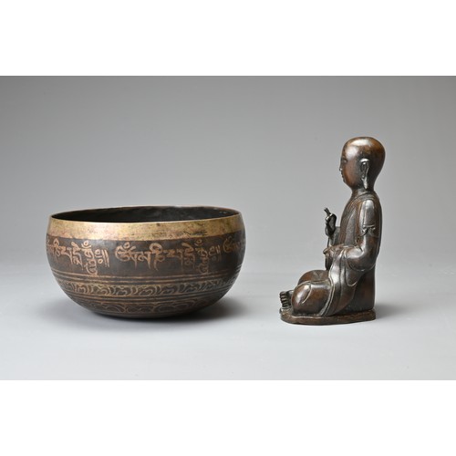 182 - TWO CHINESE TIBETAN BRONZE ITEMS. To include a singing bowl with banded decoration and Tibetan scrip... 