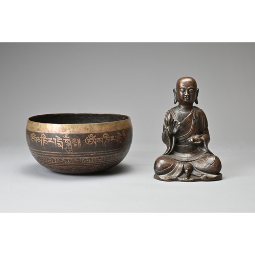 182 - TWO CHINESE TIBETAN BRONZE ITEMS. To include a singing bowl with banded decoration and Tibetan scrip... 