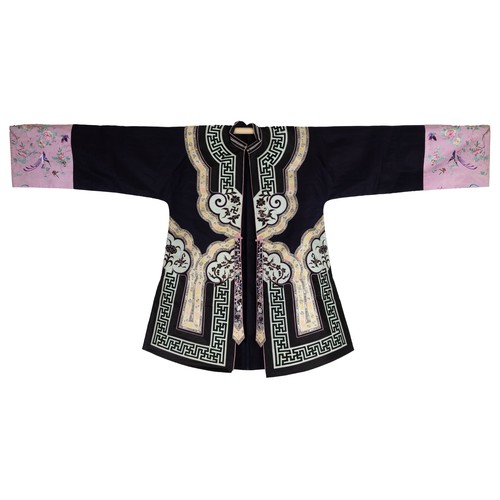 55 - TWO CHINESE EMBROIDERED SILK ROBES, CIRCA 1920 AND LATER. The first, early 20th century, in dark pur... 