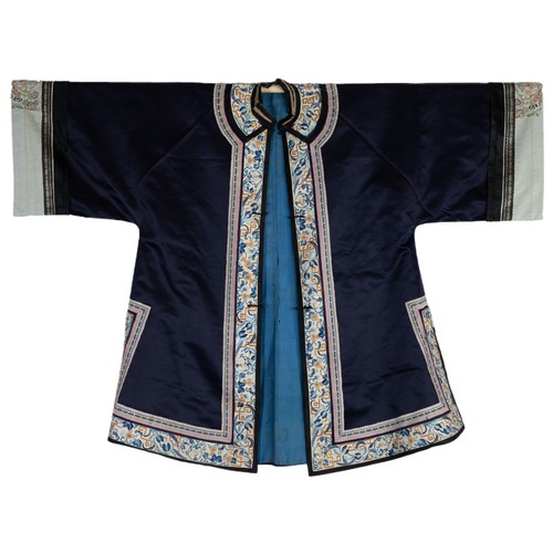 55 - TWO CHINESE EMBROIDERED SILK ROBES, CIRCA 1920 AND LATER. The first, early 20th century, in dark pur... 