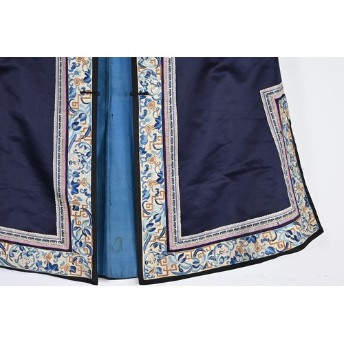 55 - TWO CHINESE EMBROIDERED SILK ROBES, CIRCA 1920 AND LATER. The first, early 20th century, in dark pur... 