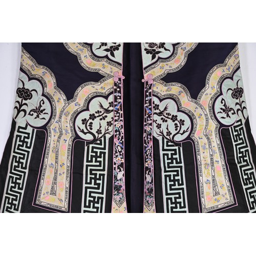 55 - TWO CHINESE EMBROIDERED SILK ROBES, CIRCA 1920 AND LATER. The first, early 20th century, in dark pur... 