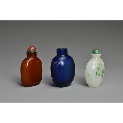 1 - THREE CHINESE GLASS SNUFF BOTTLES. To include an orange square form bottle; A blue semi translucent ... 