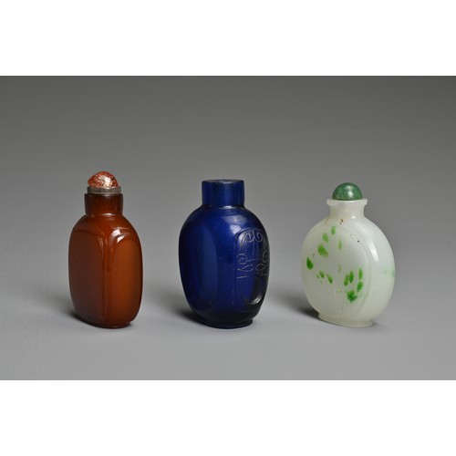 1 - THREE CHINESE GLASS SNUFF BOTTLES. To include an orange square form bottle; A blue semi translucent ... 