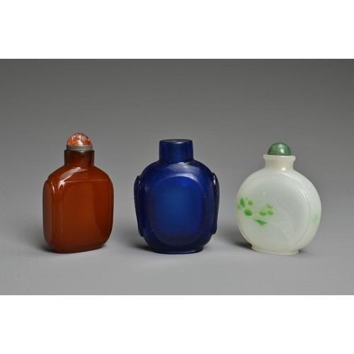 1 - THREE CHINESE GLASS SNUFF BOTTLES. To include an orange square form bottle; A blue semi translucent ... 