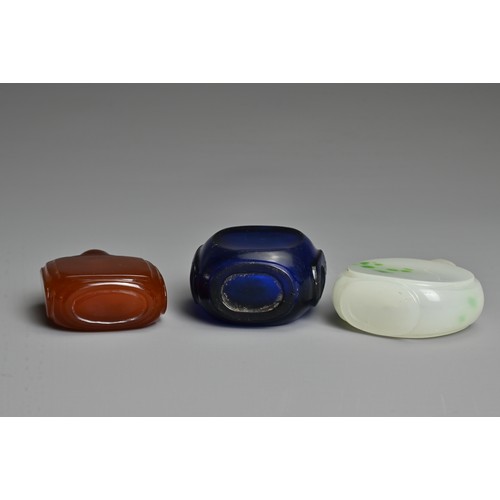 1 - THREE CHINESE GLASS SNUFF BOTTLES. To include an orange square form bottle; A blue semi translucent ... 