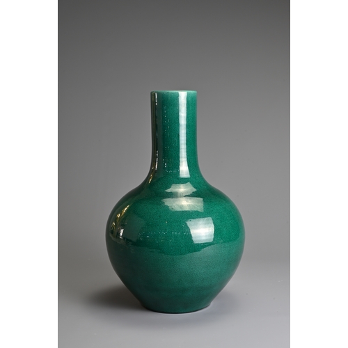 101 - A CHINESE MONOCHROME GREEN GLAZED PORCELAIN BOTTLE VASE, 20TH CENTURY. Globular body with cylindrica... 