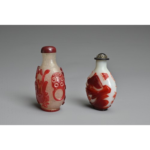 5 - TWO CHINESE RED OVERLAY GLASS SNUFF BOTTLES. To include an opaque glass bottle featuring grasshopper... 