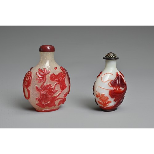 5 - TWO CHINESE RED OVERLAY GLASS SNUFF BOTTLES. To include an opaque glass bottle featuring grasshopper... 