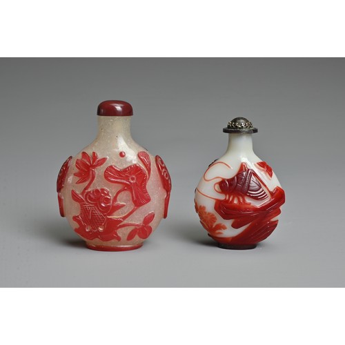 5 - TWO CHINESE RED OVERLAY GLASS SNUFF BOTTLES. To include an opaque glass bottle featuring grasshopper... 