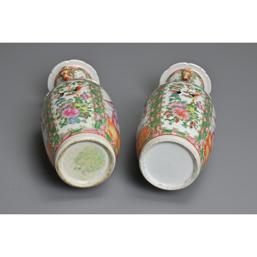 20 - A PAIR OF CHINESE CANTON FAMILLE ROSE PORCELAIN VASES, 19TH CENTURY. Rose Medallion decoration of fi... 